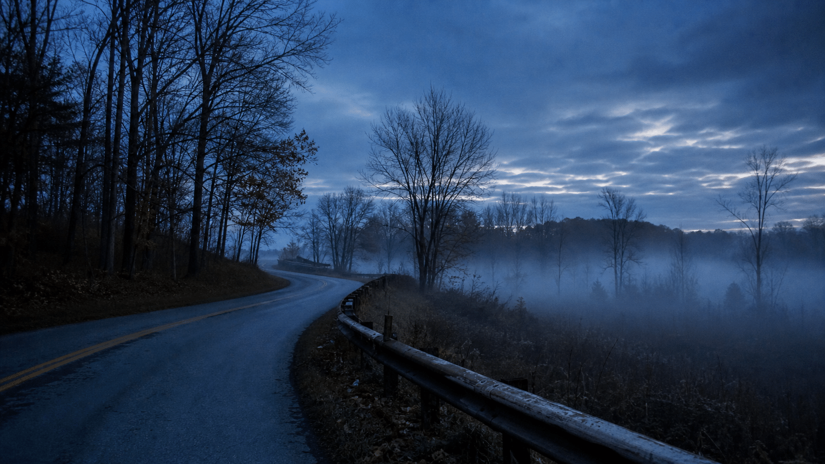 Foggy rural road bend for haunted road trip safety tips